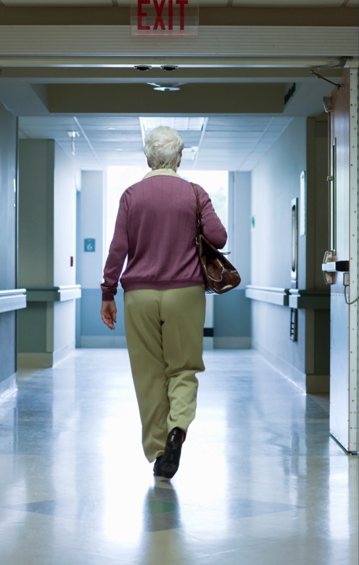 Senior woman walking hospital hallways